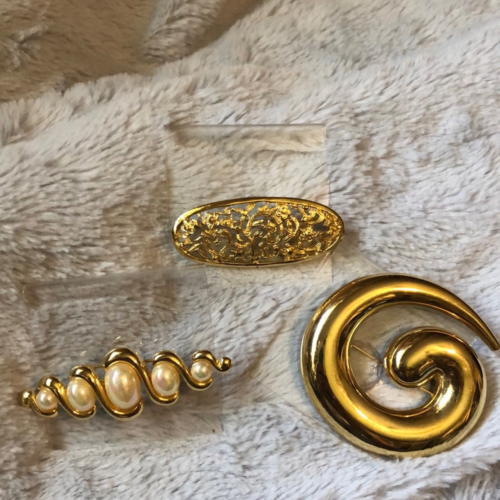 Three beautiful gold tone brooches